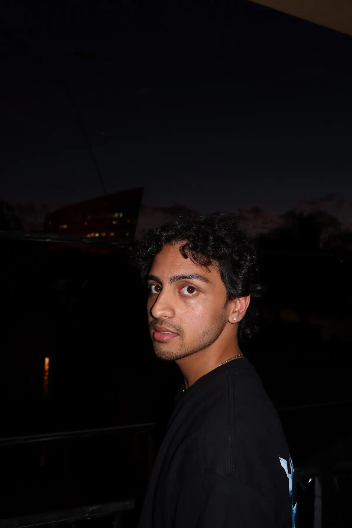 Lost, dark portrait leaning into frame